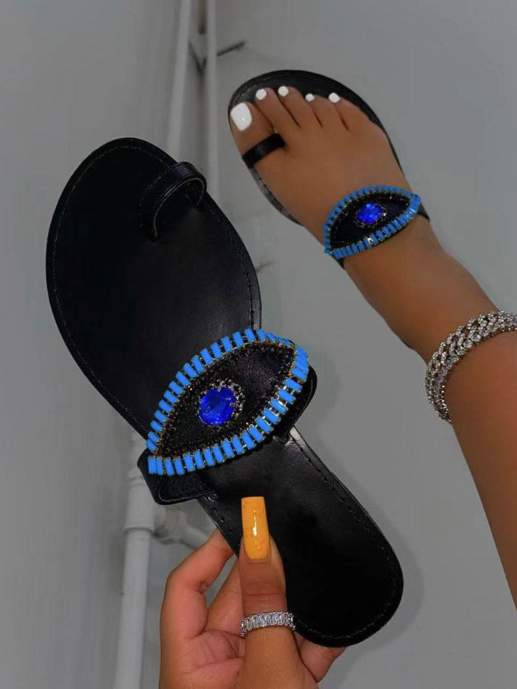 Slip-On-Sandalen mit bösem Blick