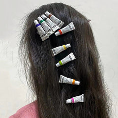 Pinzas para el cabello con tubos de pintura